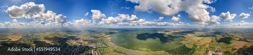 Fotografie Aerial view from high altitude of earth covered with white puffy cumulus clouds