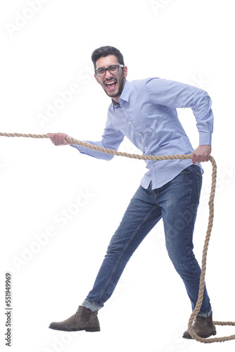 purposeful young man pulls the rope. isolated on a white background.