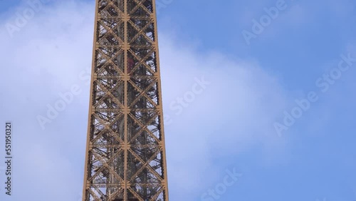 Eiffel Tower against Blue Sky With an Airplane Passing By photo