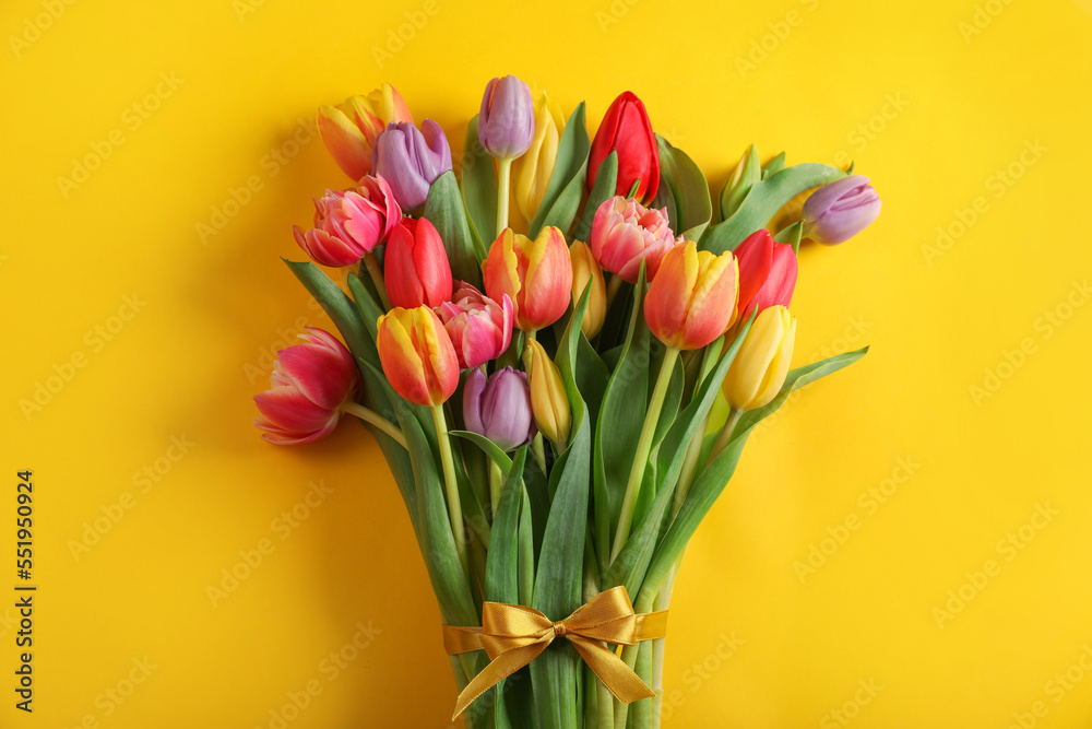 Bunch of beautiful tulips on yellow background, top view Bunch of beautiful tulips on yellow background, top view