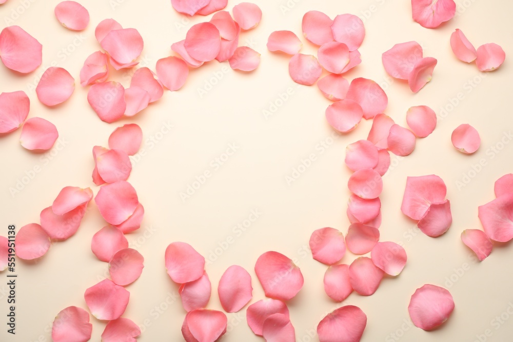 Beautiful pink rose flower petals on beige background, flat lay. Space for text