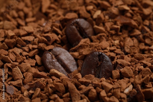 Roasted beans on instant coffee, closeup view
