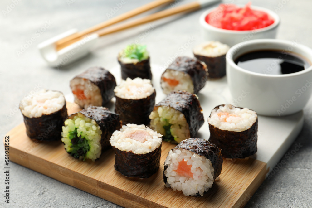 Tasty sushi rolls served on grey table, closeup Tasty sushi rolls served on grey table, closeup