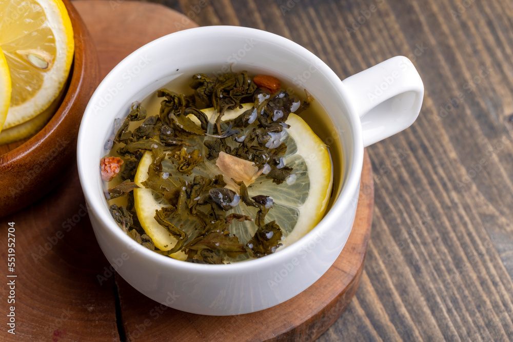 Green tea in a white cup during its brewing Green tea in a white cup during its brewing