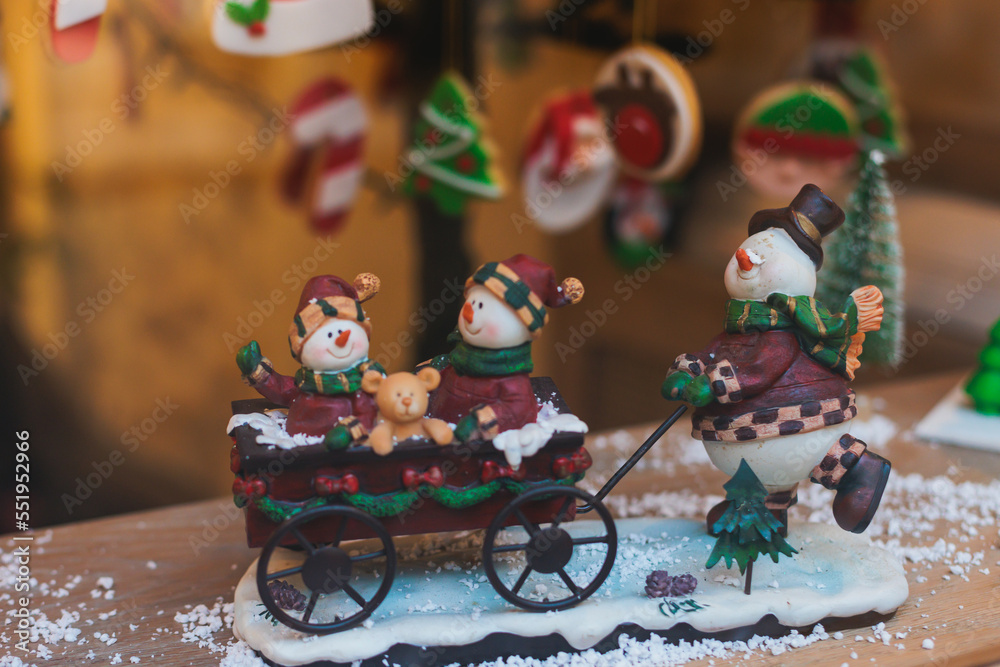 Christmas market details with New Year decorations and multicolored flags, garlands and festoons, Xmas atmosphere, fair interior, retail and store with illumination, New Year glowing decor