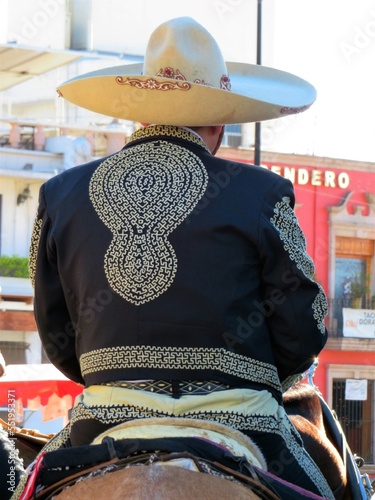 a person on a horse in traditional charro costume, mexico photo