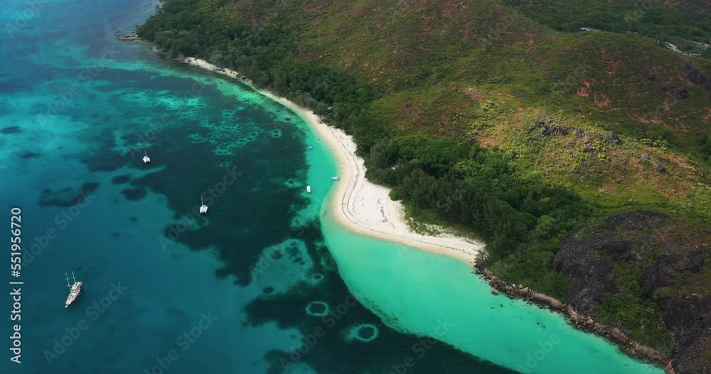 Aerial view over a beach with boats on Praslin Island in the Seychelles, Africa. Aerial view over a beach with boats on Praslin Island in the Seychelles, Africa.