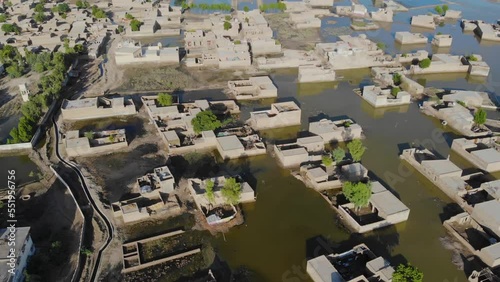 Aerial View Of Rural Buildings Under Floodwater In Sindh. Dolly Forward, Tilt Up photo