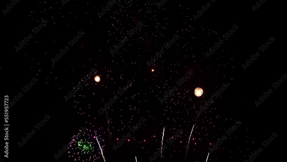Bars of white light dissolves into brightly colored fireworks.