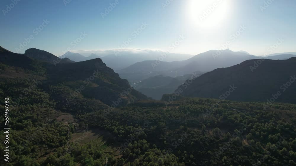 Aerial Rising Shot Of Forest Valley Hillside In Spain With High Sun Aerial Rising Shot Of Forest Valley Hillside In Spain With High Sun