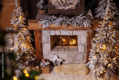 close-up decorated christmas fireplace with lights at night