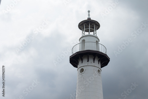 Lighthouse on the backdrop of a cloudy sky of the rainy season.