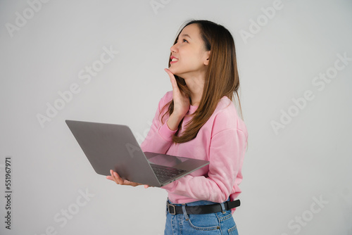 Asian girl holding laptop on white background