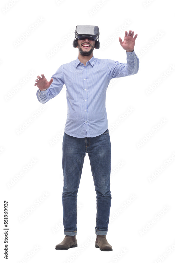 in full growth. smiling young man wearing virtual reality glasses. in full growth. smiling young man wearing virtual reality glasses.
