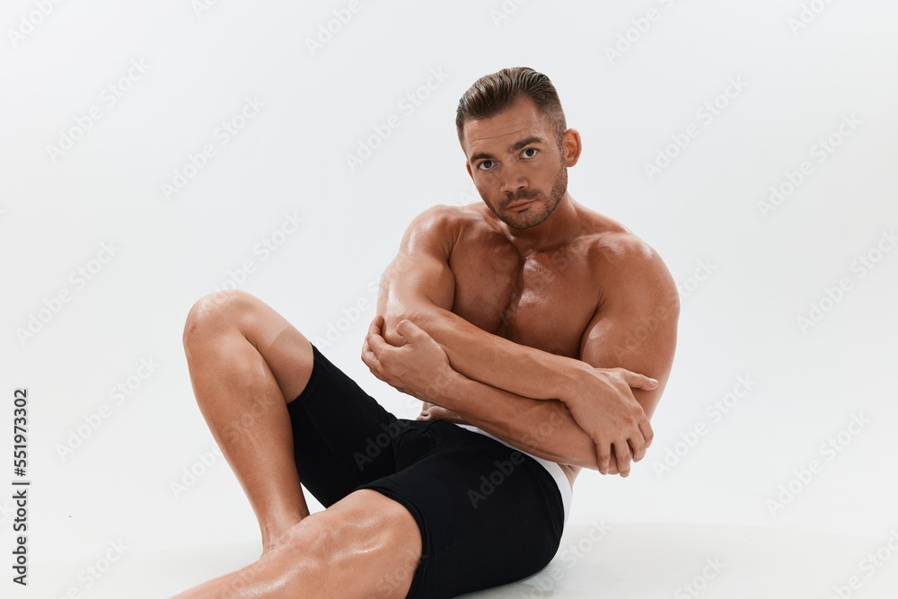 Man athletic body bodybuilder in briefs with naked torso abs full-length in the background, fitness classes. Advertising, sports, active lifestyle, competition, challenge concept.