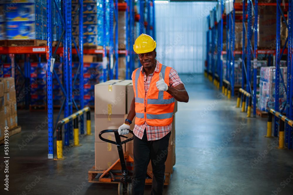 Industrial African American workers pulling pallet truck in warehouse factory. import export shipping logistics industrial transportation concept Industrial African American workers pulling pallet truck in warehouse factory. import export shipping logistics industrial transportation concept