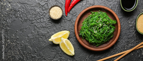 Plate with tasty seaweed salad on dark background with space for text