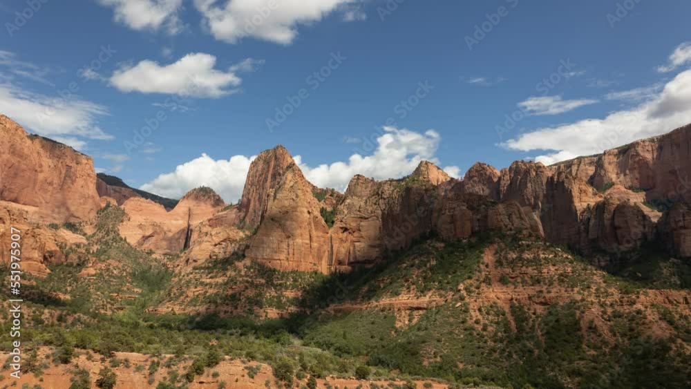Cumulonimbus clouds form and drift across the sky casting shadows on the mountains of Kolob Canyon in Zion Nat. park Utah on a warm summer day. Cumulonimbus clouds form and drift across the sky casting shadows on the mountains of Kolob Canyon in Zion Nat. park Utah on a warm summer day.