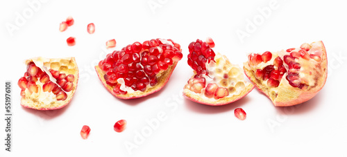 Juicy pomegranate berries isolated on white background.
