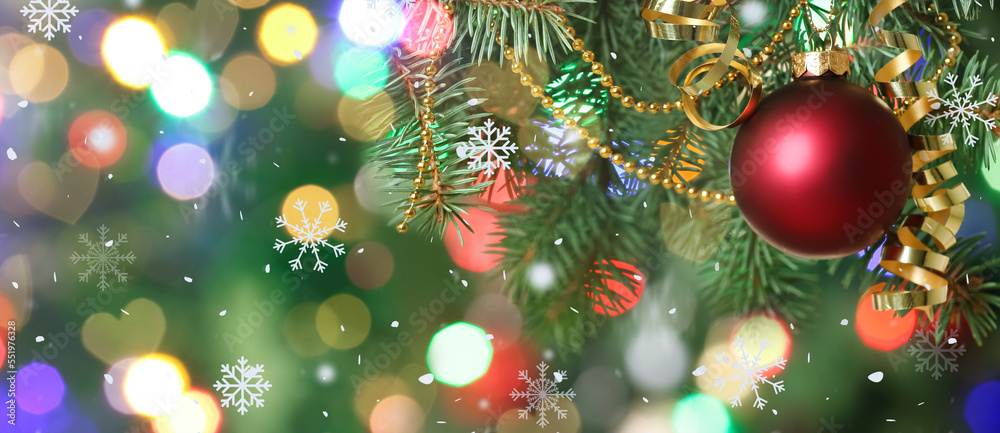 Christmas ball and decor on fir tree against blurred lights, closeup