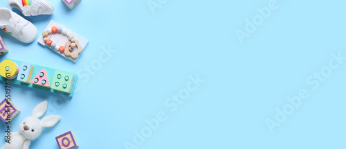 Set of children's toys with booties on blue background with space for text © Pixel-Shot