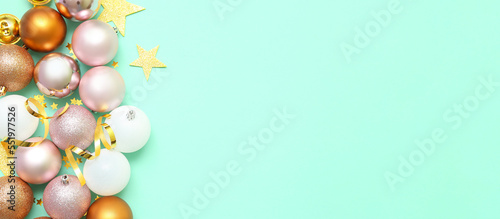 Beautiful composition with Christmas balls on turquoise background with space for text