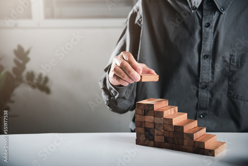 Fotografiet Business hand arranging put wooden block stacking step stair growth success proc