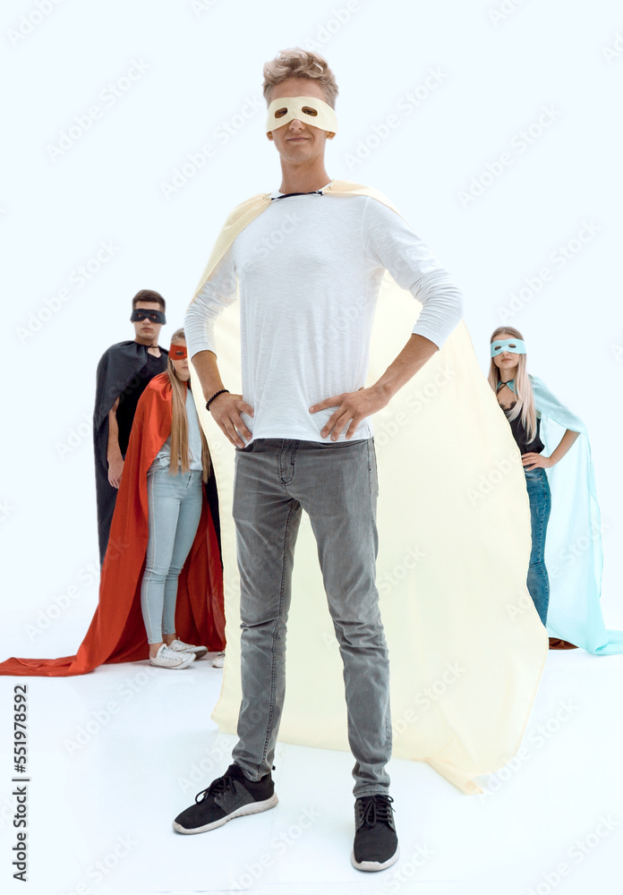 in full growth. confident guy superhero and his super team in full growth. confident guy superhero and his super team