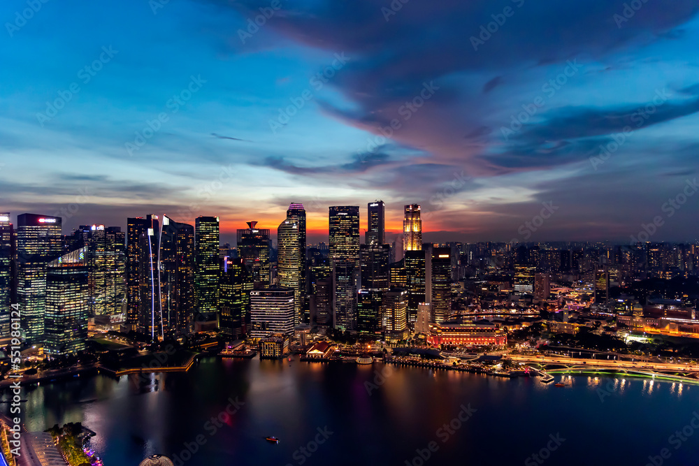 Southeast Asia, Singapore, November, 2022: Aerial view of Singapore city business skyscrapers and financial district with evening illumination on sunset