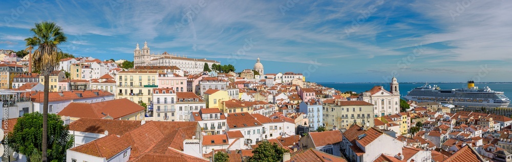 Panoramic view of Lisbon Portugal with red roofs, palaces, port with ships