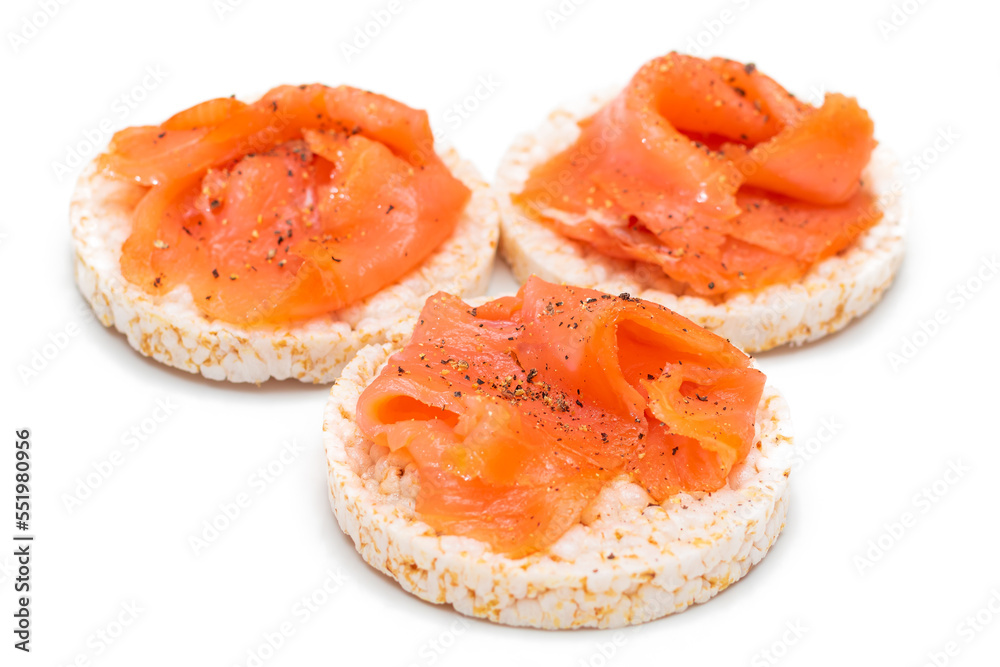 Tasty Rice Cake Sandwiches with Fresh Salmon Slices Isolated on White. Easy Breakfast and Diet Food. Crispbread with Red Fish. Healthy Dietary Snacks - Isolation Tasty Rice Cake Sandwiches with Fresh Salmon Slices Isolated on White. Easy Breakfast and Diet Food. Crispbread with Red Fish. Healthy Dietary Snacks - Isolation