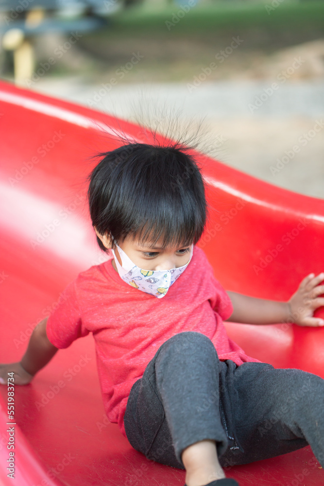 Asia child smiling playing on slider bar toy outdoor playground, happy preschool little kid having funny while playing on the playground equipment in the daytime in summer. Asia child smiling playing on slider bar toy outdoor playground, happy preschool little kid having funny while playing on the playground equipment in the daytime in summer.