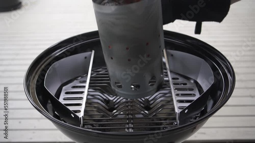 Pouring Heated BBQ Charcoal Heat Beads, Briquettes and BBQ Fuel into charcoal baskets
