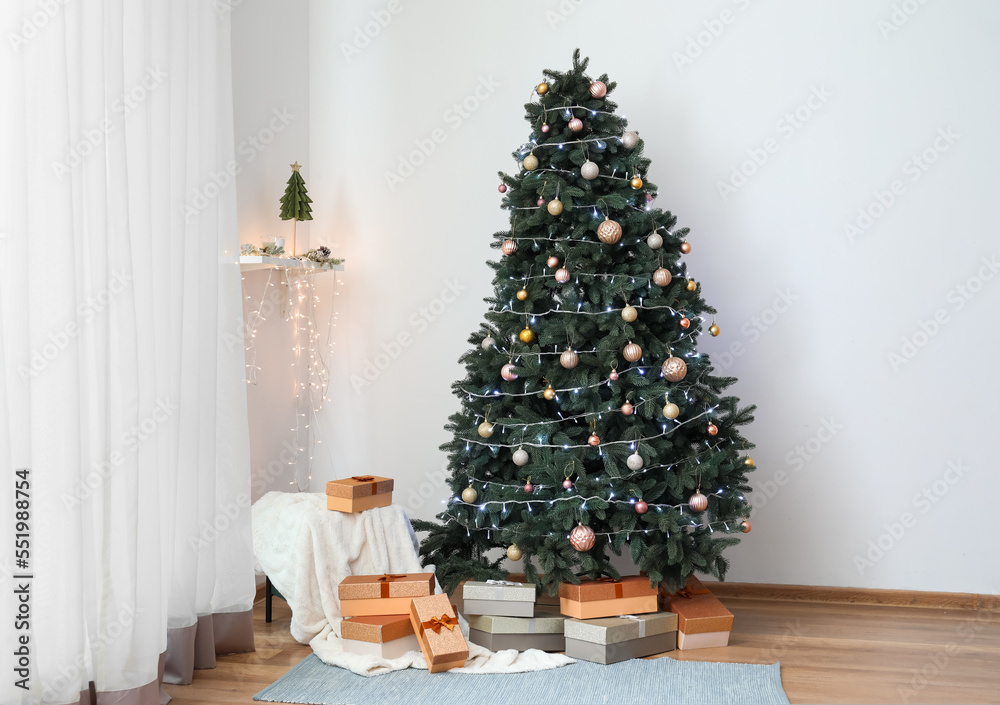 Beautiful Christmas tree with presents and pouf in living room Beautiful Christmas tree with presents and pouf in living room