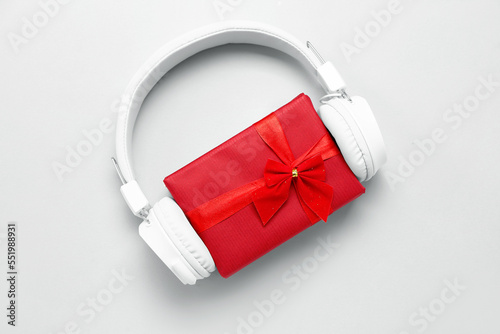 Headphones with Christmas gift on white background