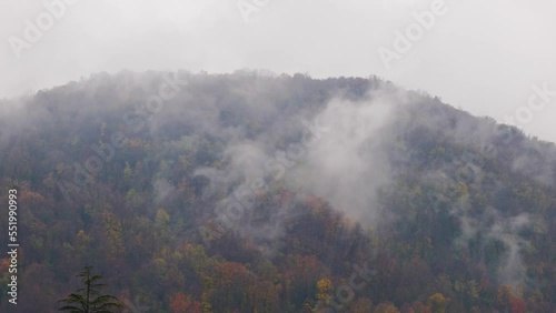 Mountain Peak with Autumn Trees and Storm Clouds in Caslano, Ticino, Switzerland. photo