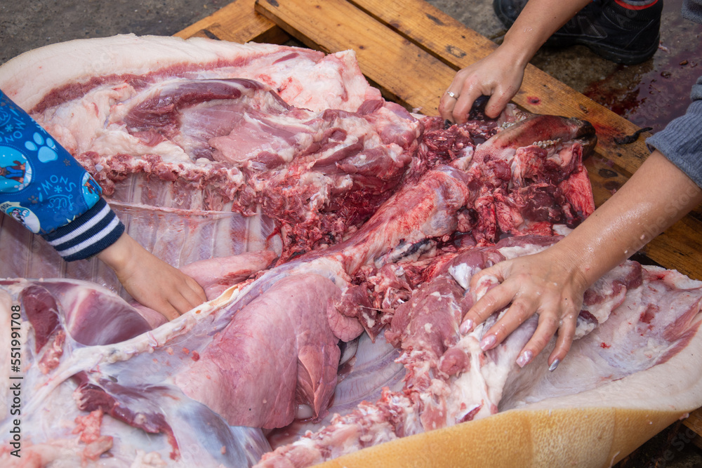 Butchering the pig in the Romanian countryside is an old tradition. Meat cutting detail