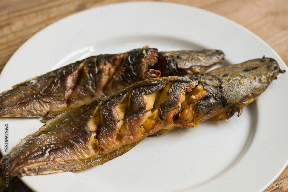 grilled catfish on white plate, Thailand food cooking catfish freshwater fish grilled catfish on white plate, Thailand food cooking catfish freshwater fish
