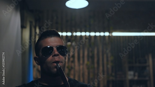 Arabic jordanian young man smokes a hookah. photo