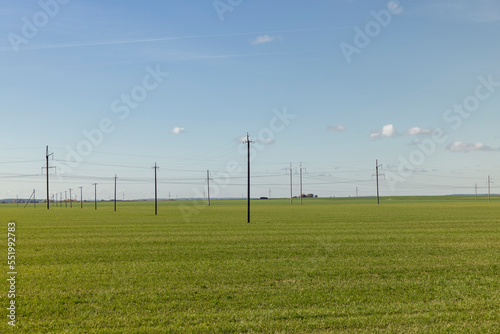 High-voltage poles installed in the field for electric lines
