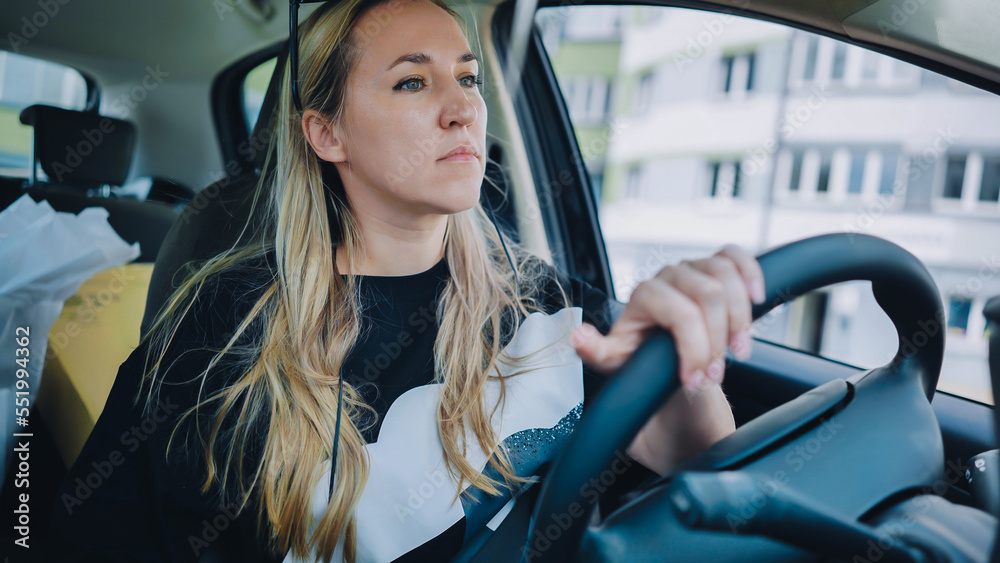 A young woman driving a car is driving on the highway. A young woman driving a car is driving on the highway.