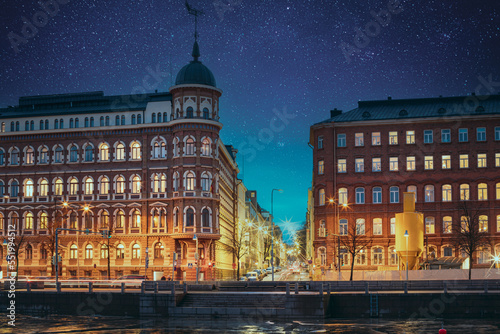 Helsinki, Finland. Bright Blue Starry Sky Above Crossroad Of Pohjoisranta And Kirkkokatu Street In Evening Or Night Illumination. Light Blue Dramatic Sky. Azure Color Sky.