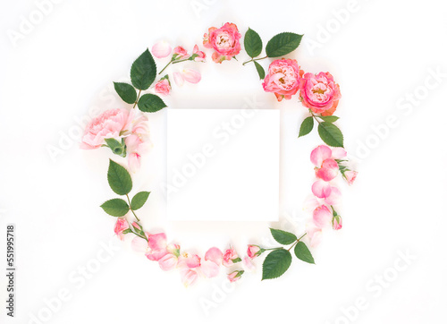 Blank square paper card mockup in the centre of floral composition on white background. Graphic design elements.