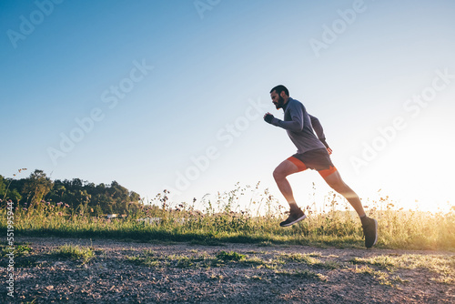 Man running in the countryside at sunrise