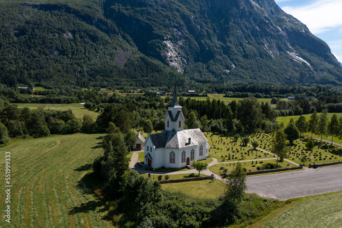 aerial view of a church in norway with mountains