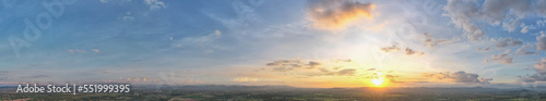 Aerial view of the sunset sky, Panoramic beautiful landscape with twilight sky, Sun bursting through clouds.