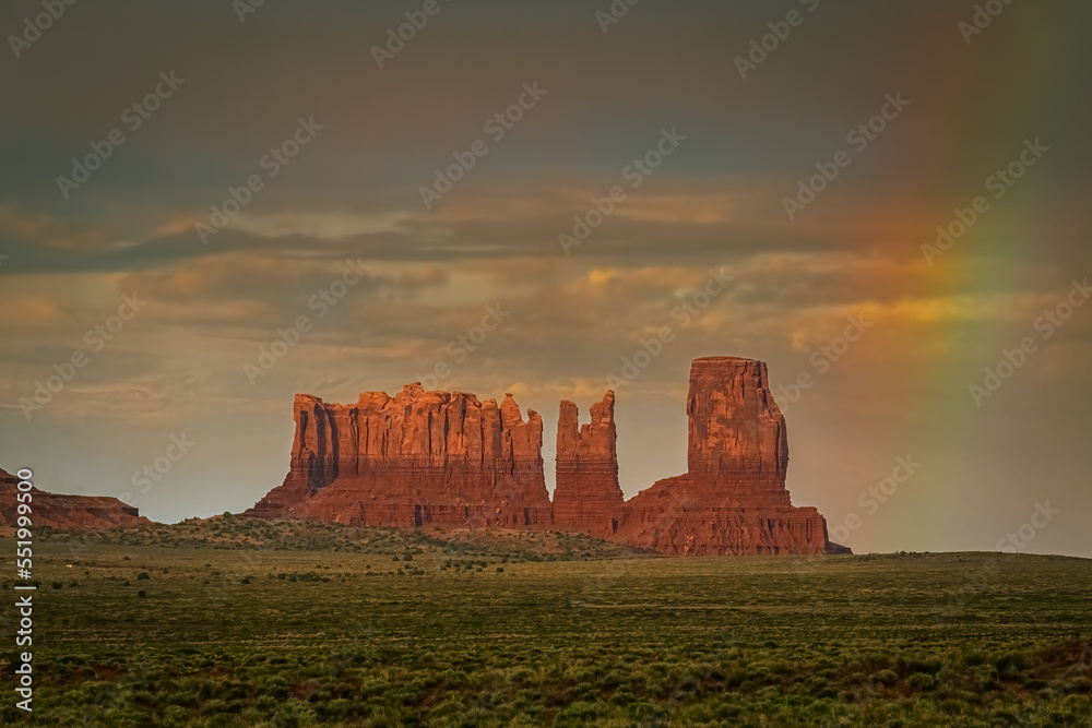 Fototapeta premium View of beautiful rock formations in Monument Valley Tribal Park, USA, with rainbow in background