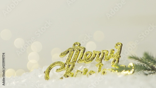 Golden merry christmas text with bokeh lights in the background