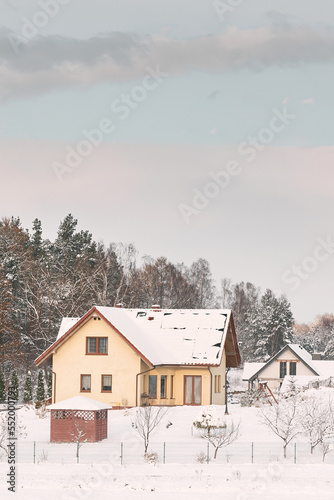 Cozy wooden house covered with snow. © AlexGo