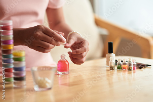 Woman Applying Pink Nail Polish